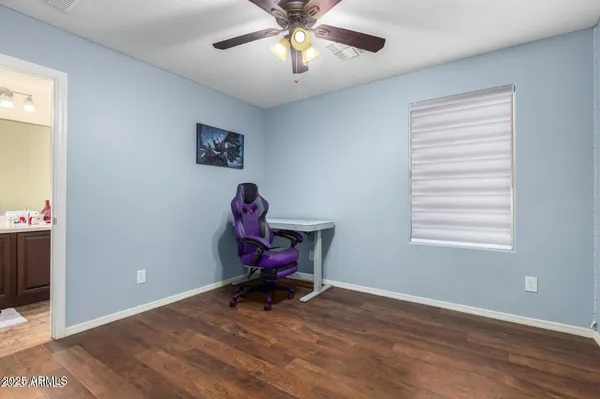 a view of a workspace with furniture and a window
