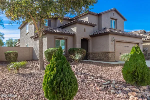 a front view of a house with garden