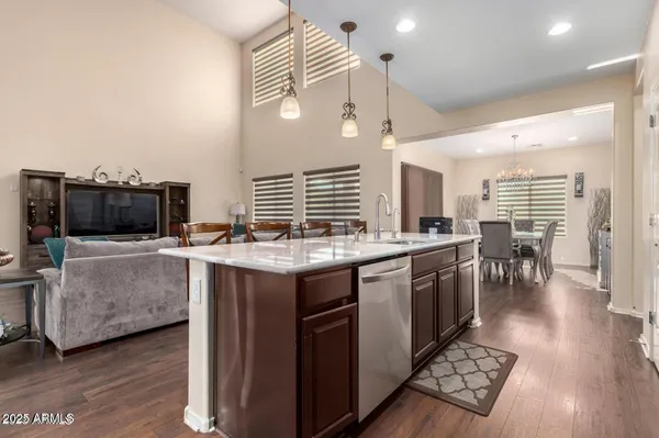 a kitchen with a stove and a wooden floor