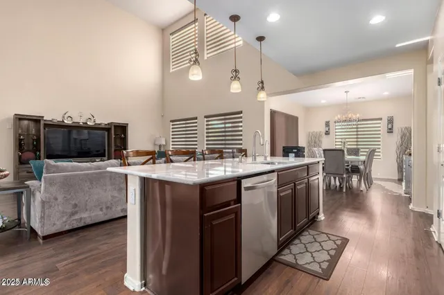 a kitchen with a stove and a wooden floor