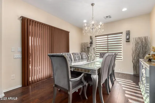 a view of a a dining room with furniture window and wooden floor