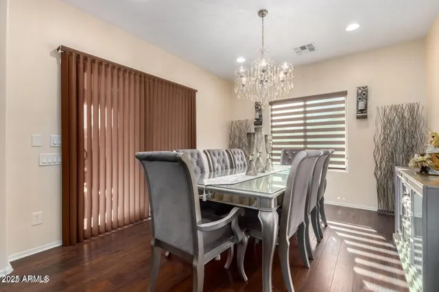 a view of a a dining room with furniture window and wooden floor