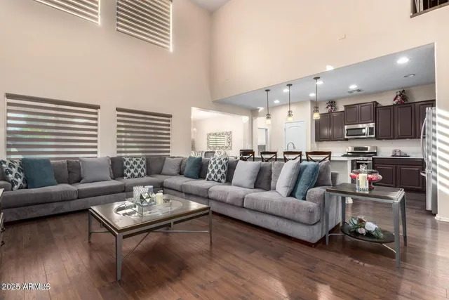 a living room with furniture kitchen and a table