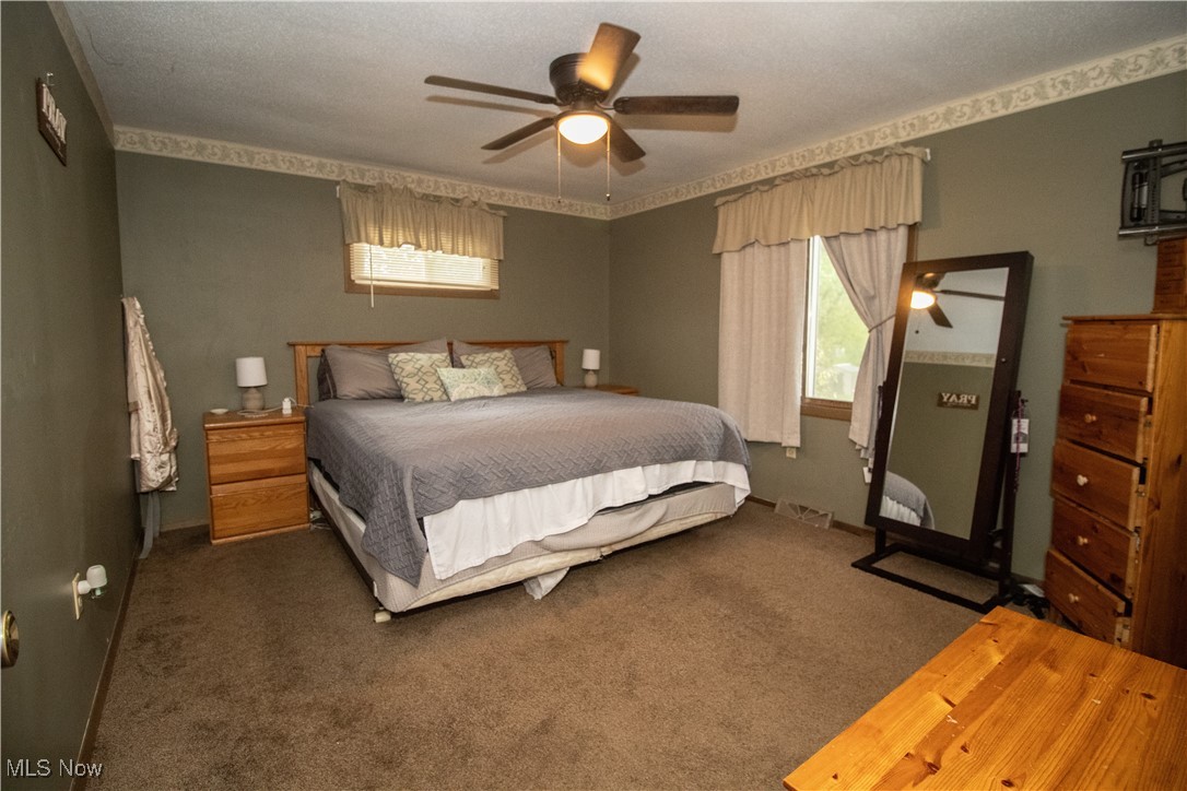 6333 Warren - Sharon Road Brookfield, OH 44403 - Photo 14 of 22 Bedroom featuring carpet flooring, a textured ceiling, and ceiling fan