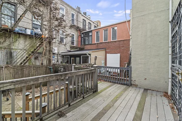 a view of a house with wooden deck