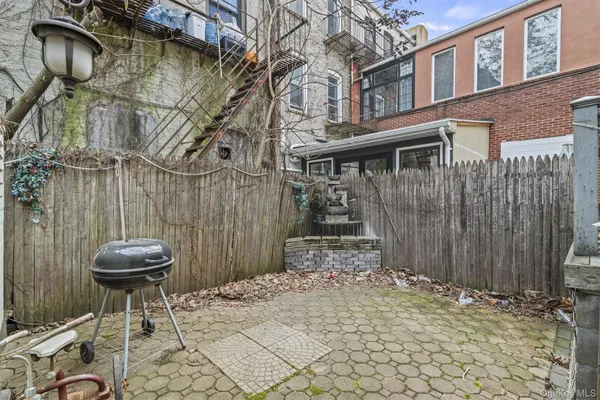 a view of a backyard with a table and chairs