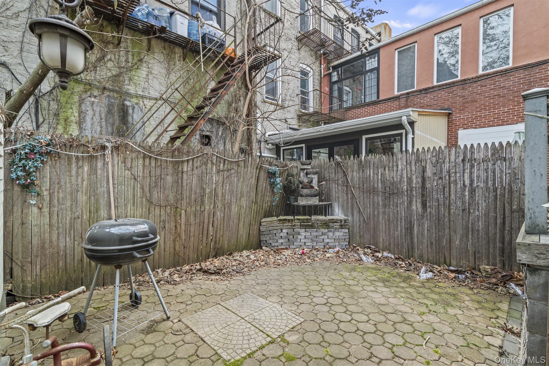 44 Decatur Street, Unit 1 Brooklyn, NY 11216 - Photo 13 of 18 a view of a backyard with a table and chairs