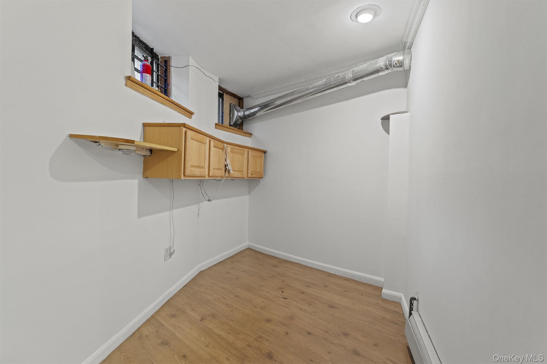 44 Decatur Street, Unit 1 Brooklyn, NY 11216 - Photo 15 of 18 a view of a room with racks on the wall