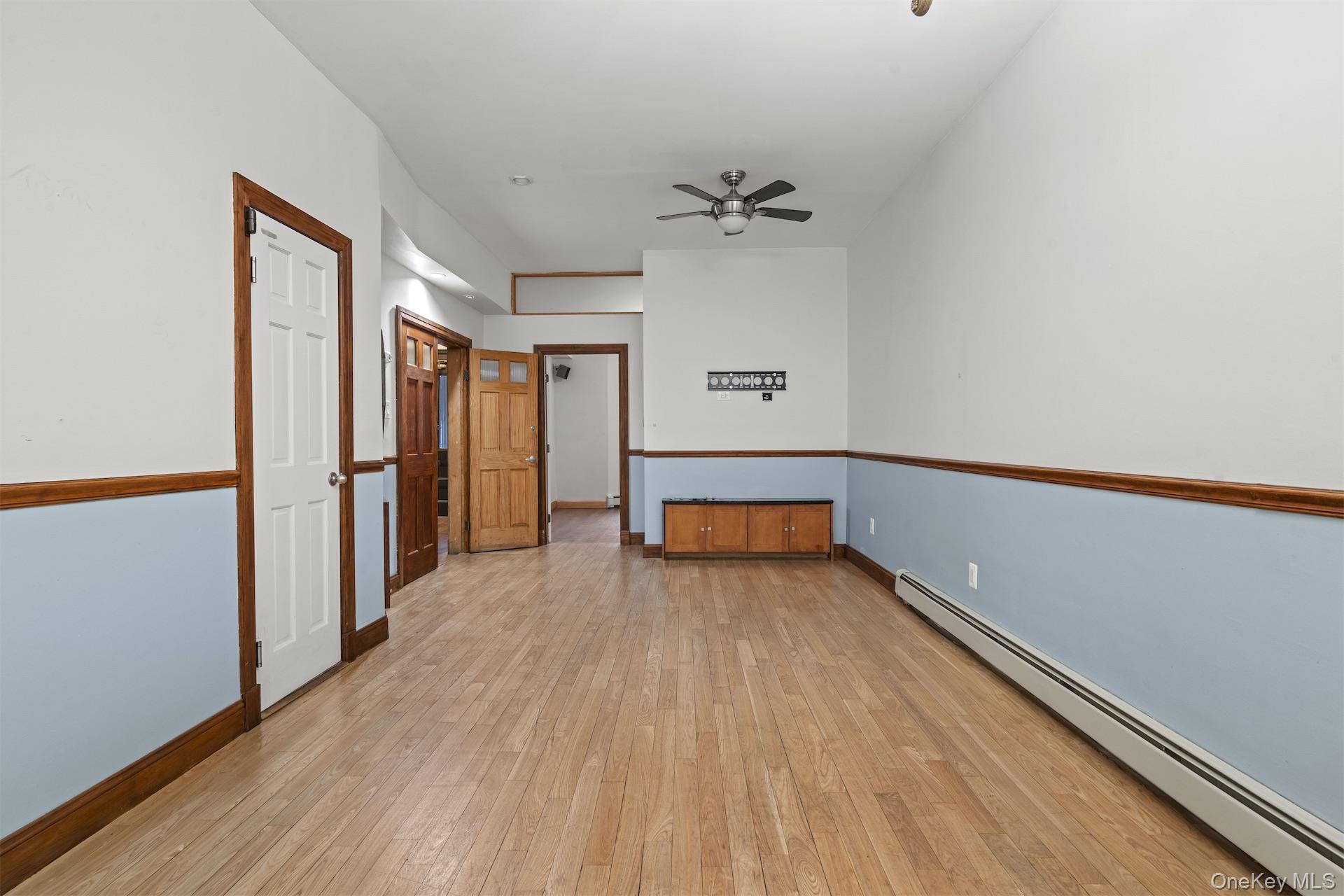 44 Decatur Street, Unit 1 Brooklyn, NY 11216 - Photo 3 of 18 wooden floor in an empty room with a window