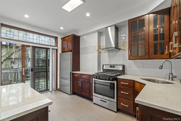 a kitchen with stainless steel appliances granite countertop a stove and a sink