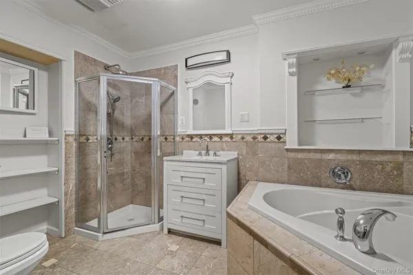 a bathroom with a granite countertop sink a toilet and shower