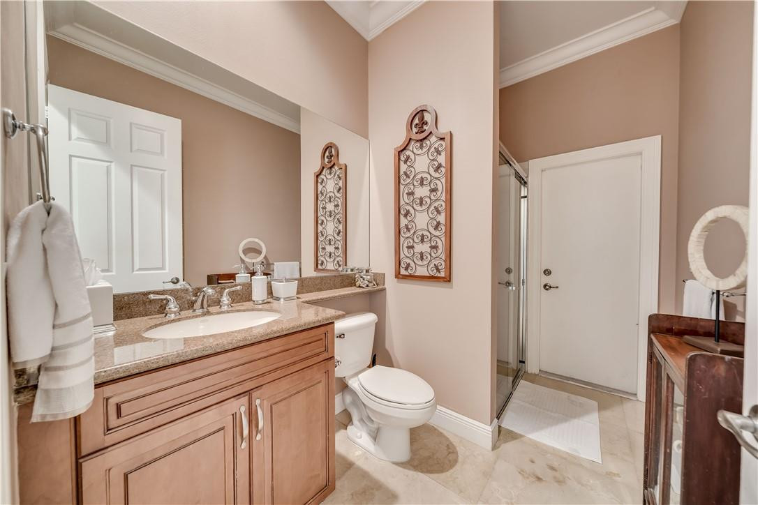 10508 Laurel Road Davie, FL 33328 - Photo 11 of 82 a bathroom with a toilet sink and mirror