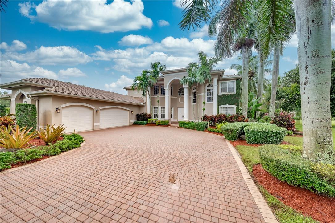 10508 Laurel Road Davie, FL 33328 - Photo 2 of 82 a front view of a house with a yard and a garage