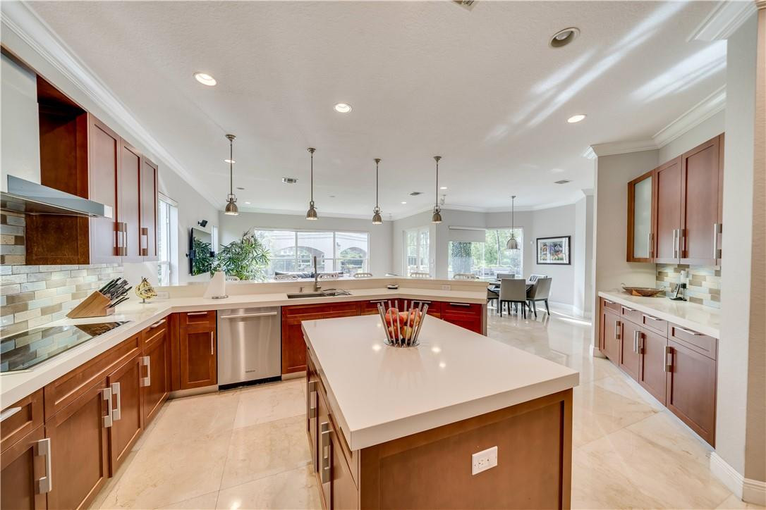 10508 Laurel Road Davie, FL 33328 - Photo 29 of 82 a kitchen with stainless steel appliances granite countertop a sink a stove and a refrigerator