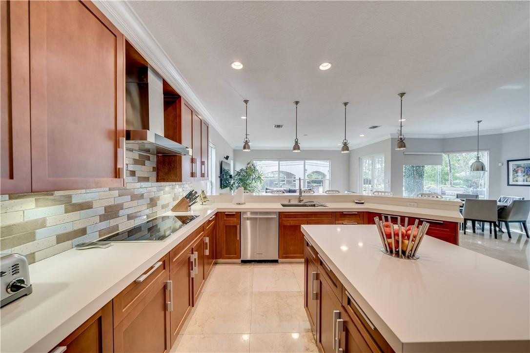 10508 Laurel Road Davie, FL 33328 - Photo 31 of 82 a kitchen with stainless steel appliances granite countertop a sink and a stove