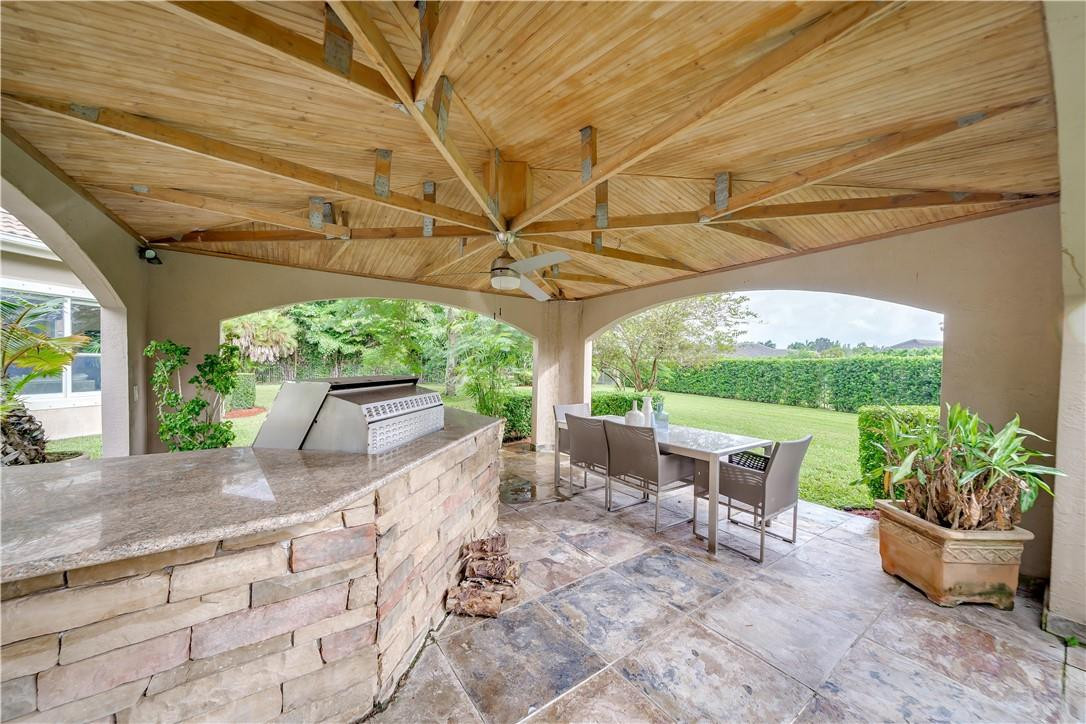 10508 Laurel Road Davie, FL 33328 - Photo 56 of 82 a view of a patio with table and chairs potted plants