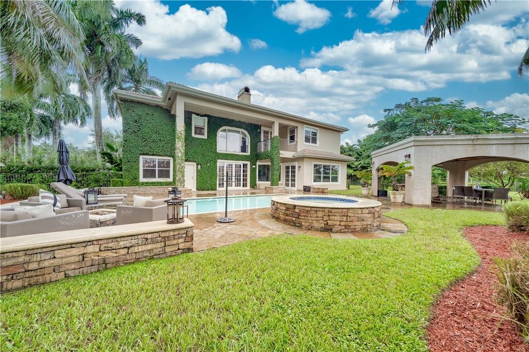10508 Laurel Road Davie, FL 33328 - Photo 64 of 82 a view of a house with a yard patio and swimming pool