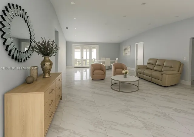 a living room with furniture and potted plant