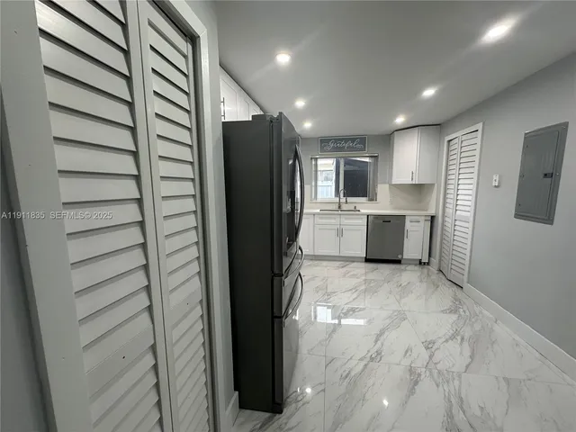 a kitchen with refrigerator and microwave