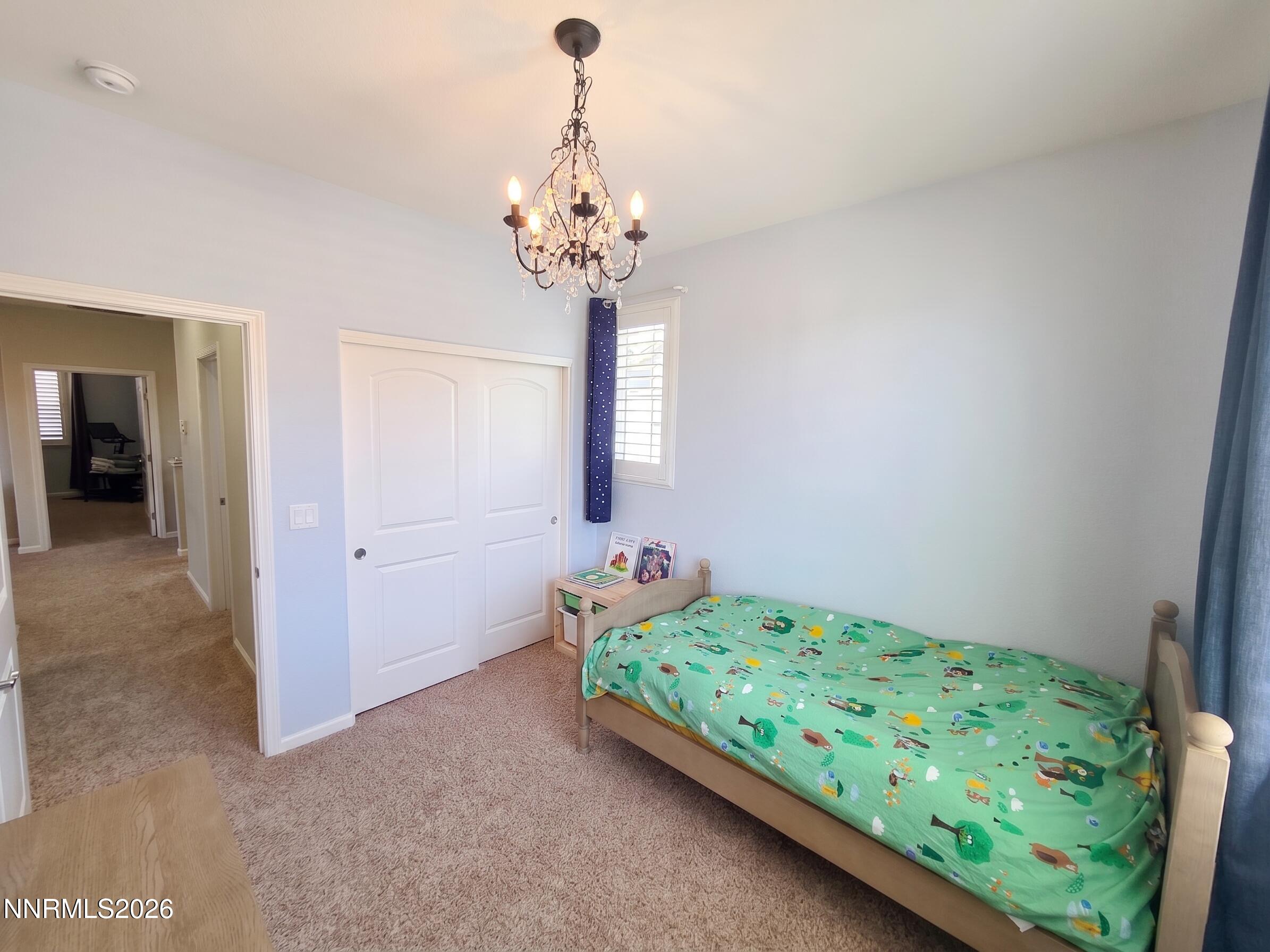 2775 Bonfire Lane Reno, NV 89521 - Photo 27 of 41 a bedroom with a bed and a chandelier