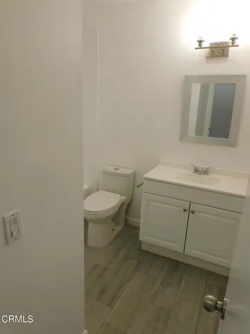 a bathroom with a sink a toilet and mirror