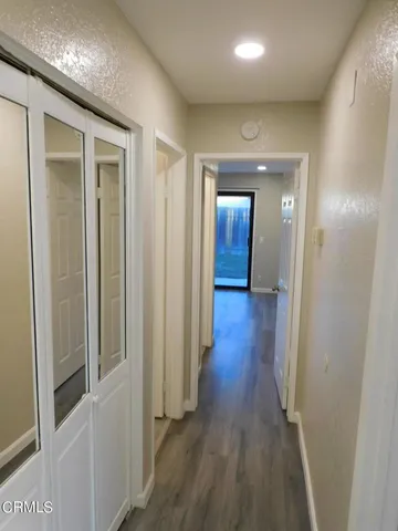 a kitchen with wooden floors and black appliances