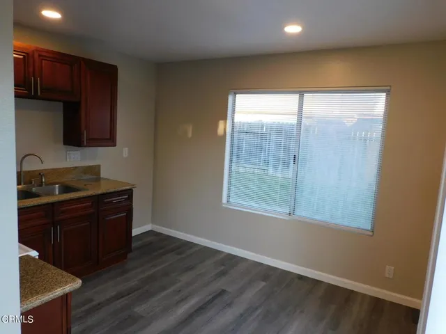 a kitchen with a sink a stove and cabinets