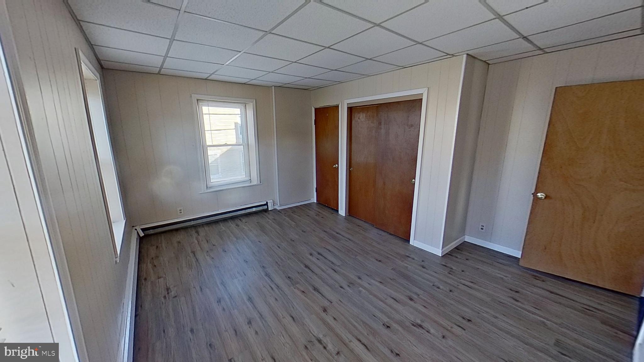1 South Main Street Loganville, PA 17360 - Photo 3 of 8 an empty room with wooden floor and windows