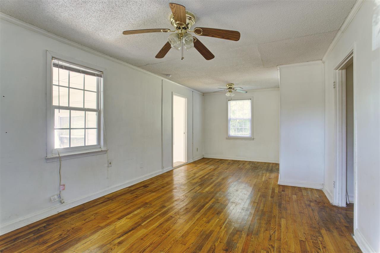 903 Tatum Road Memphis, TN 38122 - Photo 2 of 10 a view of empty room with wooden floor and fan