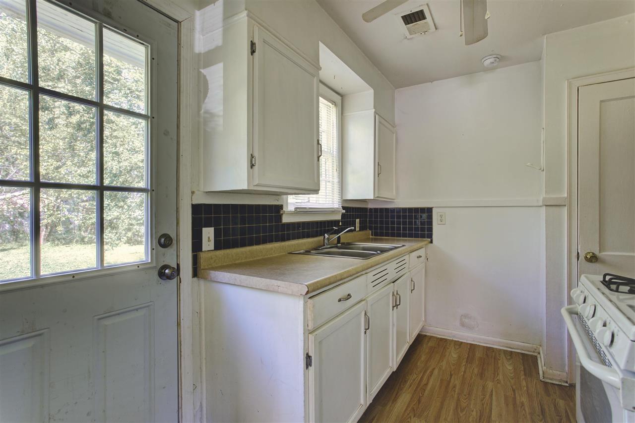 903 Tatum Road Memphis, TN 38122 - Photo 4 of 10 a bathroom with a granite countertop sink a mirror and a shower