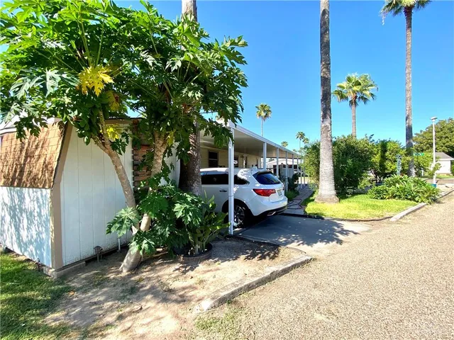 a view of a patio with table and chairs and potted plants