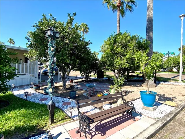 a view of a chair and table in the garden
