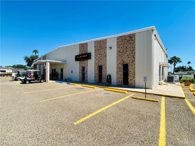 a view of a house with backyard swimming pool and sitting area