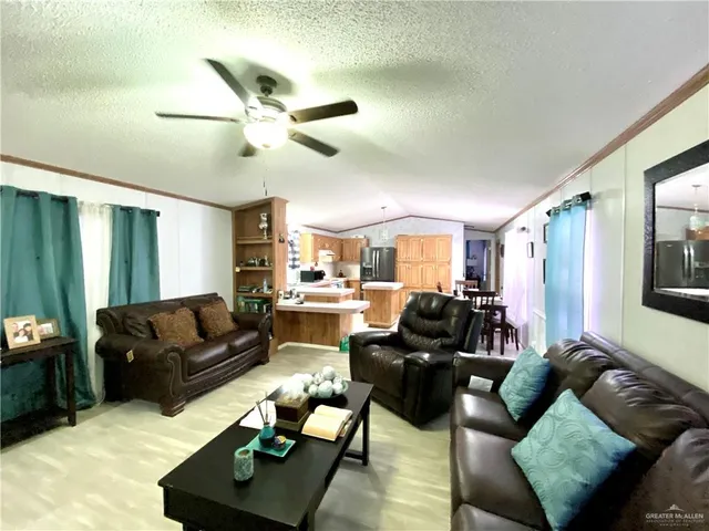 a living room with furniture and a ceiling fan