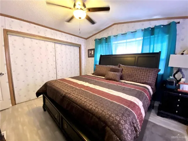a bedroom with a bed lamps and a large mirror