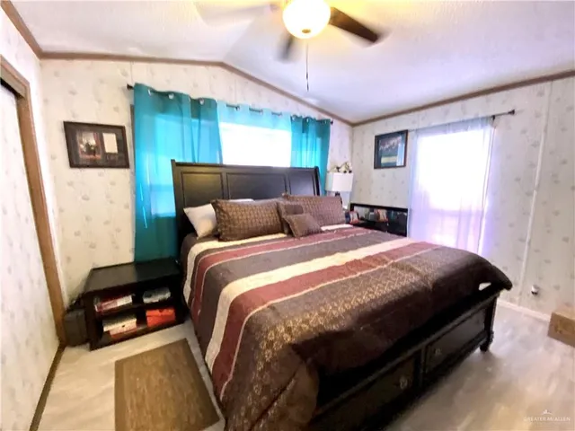 a bedroom with a bed and a mirror