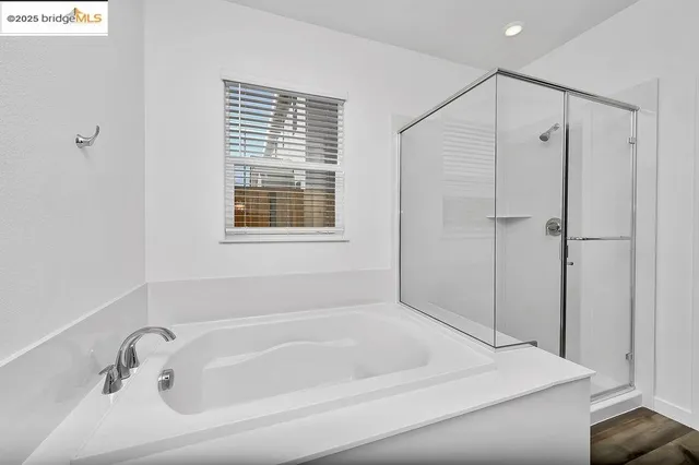 a bathroom with a tub and a window