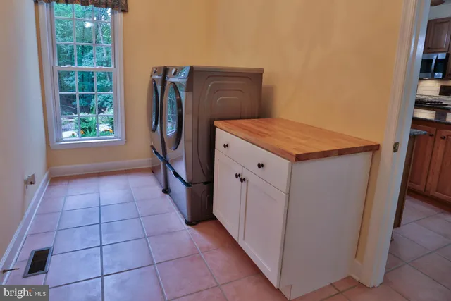 a view of a dining room with furniture and a chandelier
