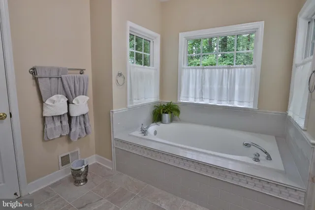 a spacious bedroom with a bed and a window