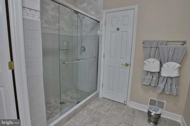 a bedroom with a bed and a lamp