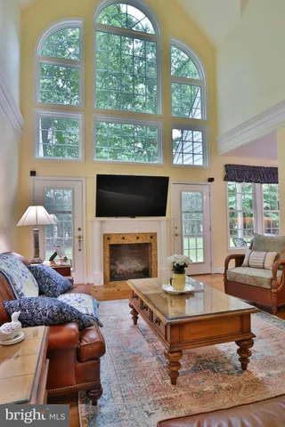 a living room with furniture fireplace and a large window