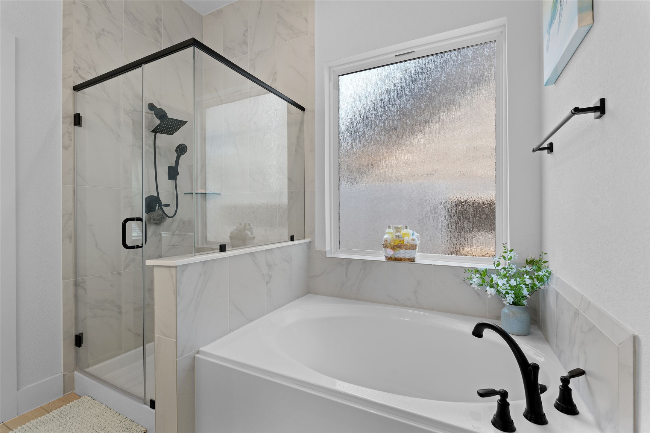 17735 Tree Of Heaven Conroe, TX 77385 - Photo 17 of 35 a bathroom with a bathtub and a shower