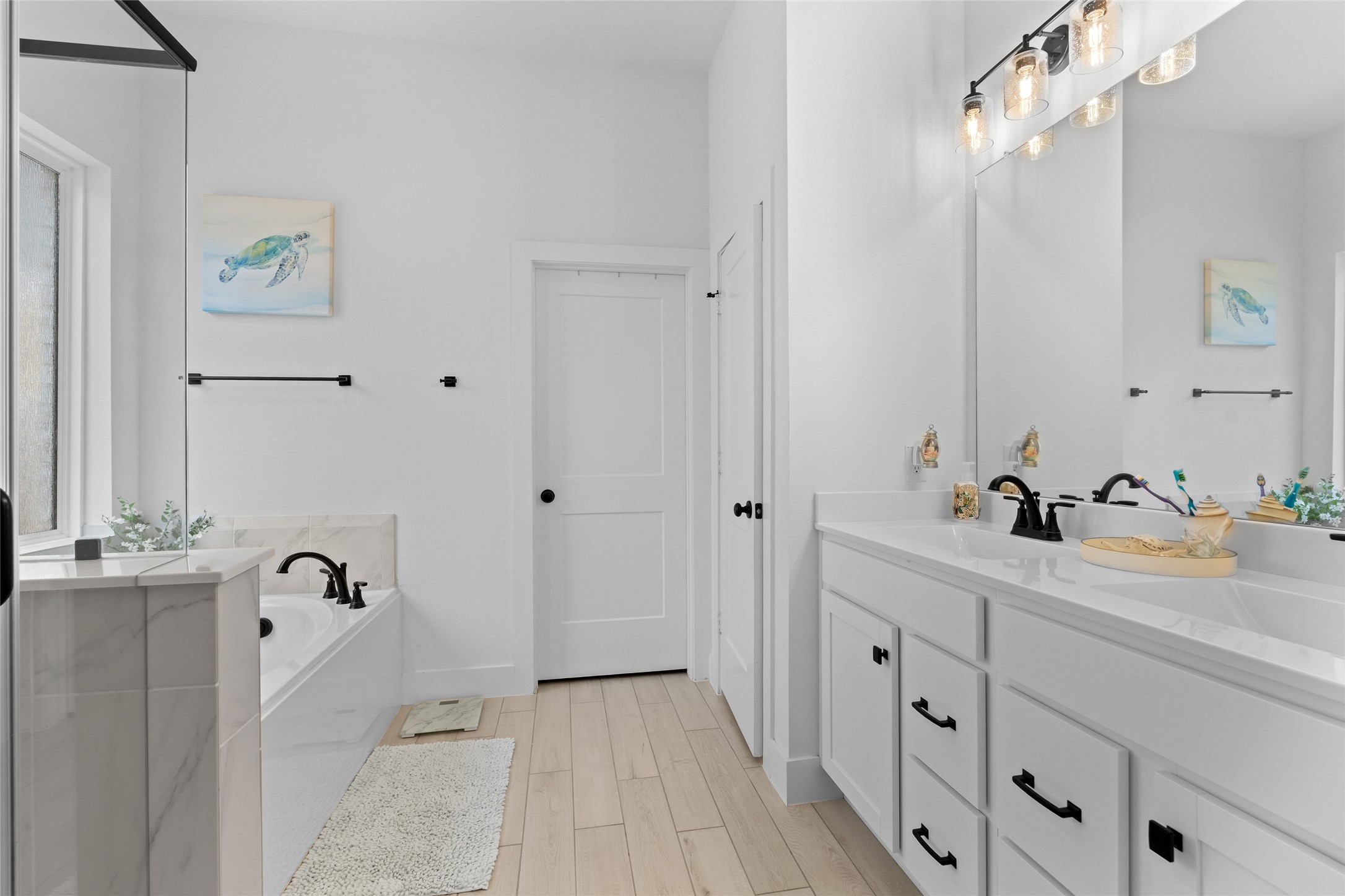 17735 Tree Of Heaven Conroe, TX 77385 - Photo 18 of 35 a bathroom with a double vanity sink a mirror and next to a window