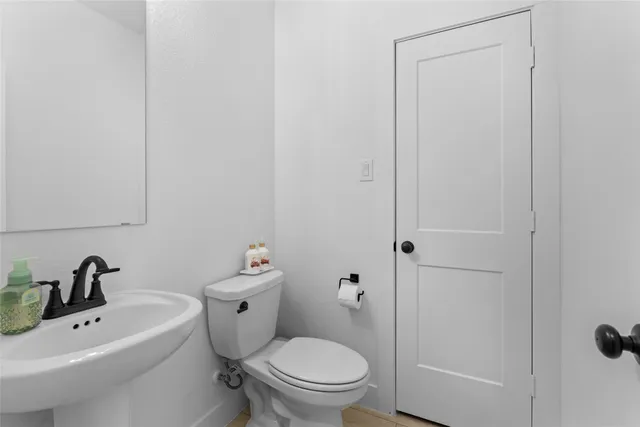 a white toilet sitting next to a bathroom sink