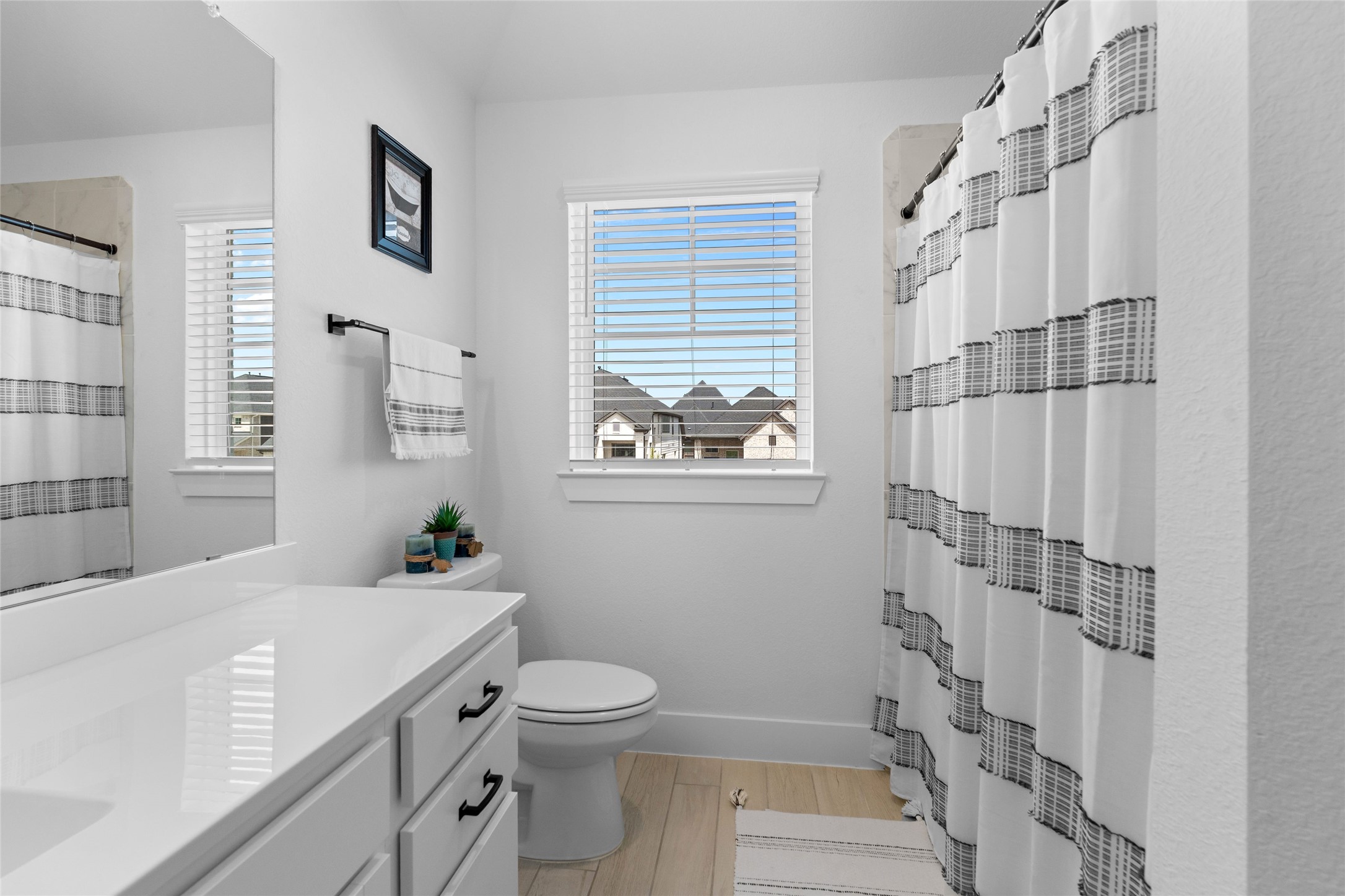 17735 Tree Of Heaven Conroe, TX 77385 - Photo 24 of 35 a bathroom with a sink a toilet and shower curtain