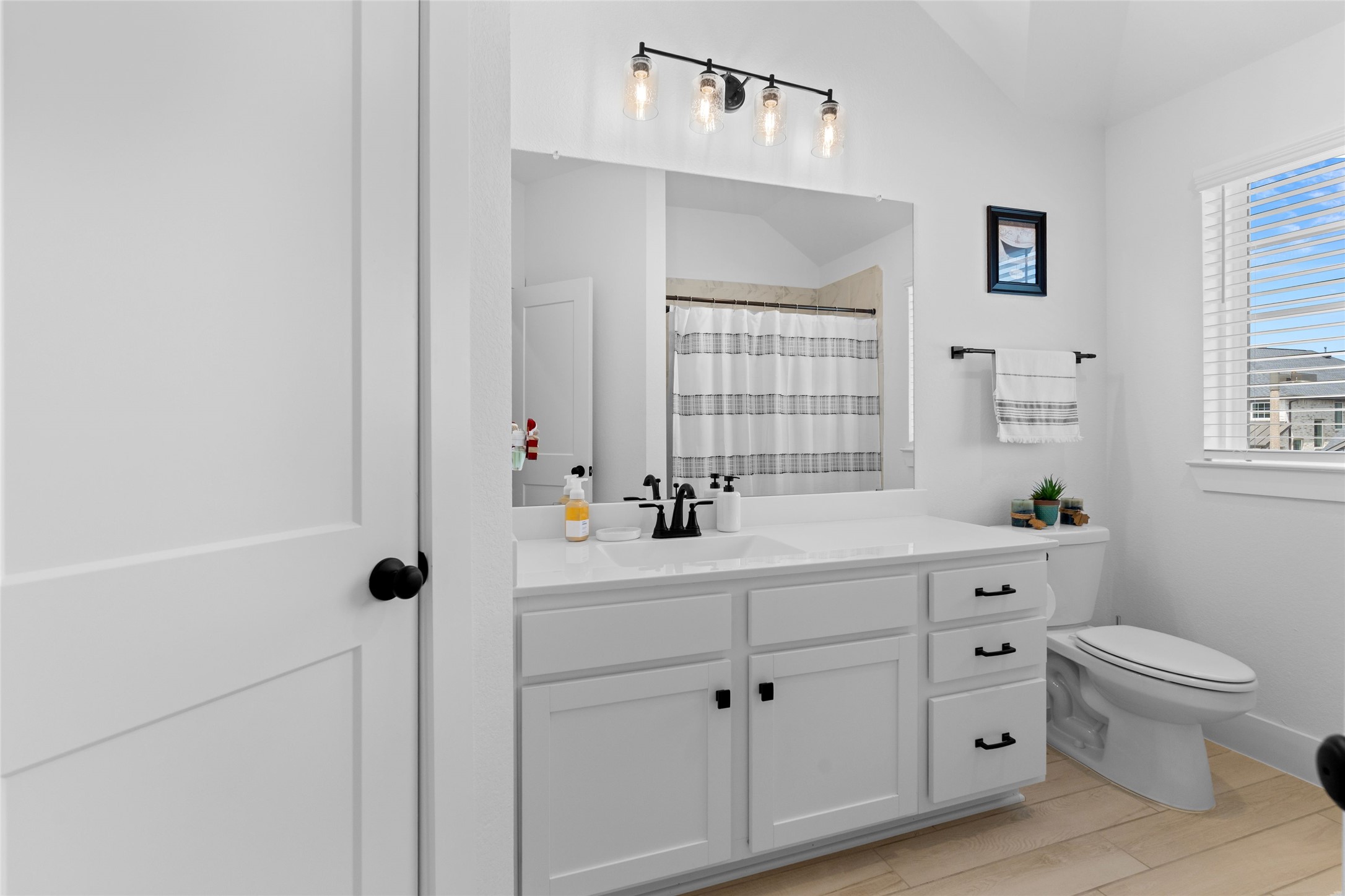 17735 Tree Of Heaven Conroe, TX 77385 - Photo 25 of 35 a bathroom with a double vanity sink a toilet and a window
