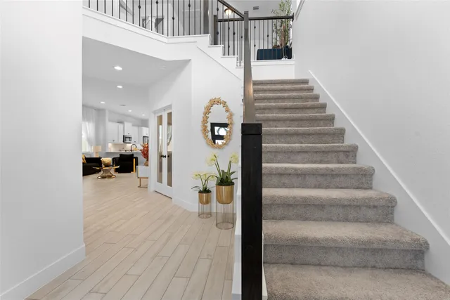 a view of entryway and hall with wooden floor