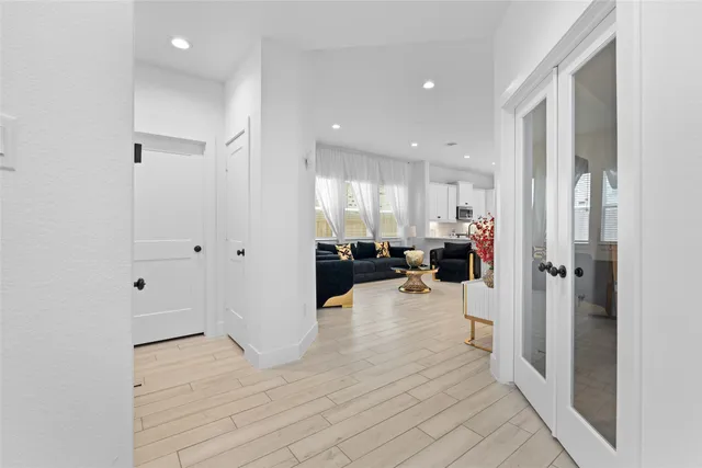 a view of a living room kitchen and a wooden floor
