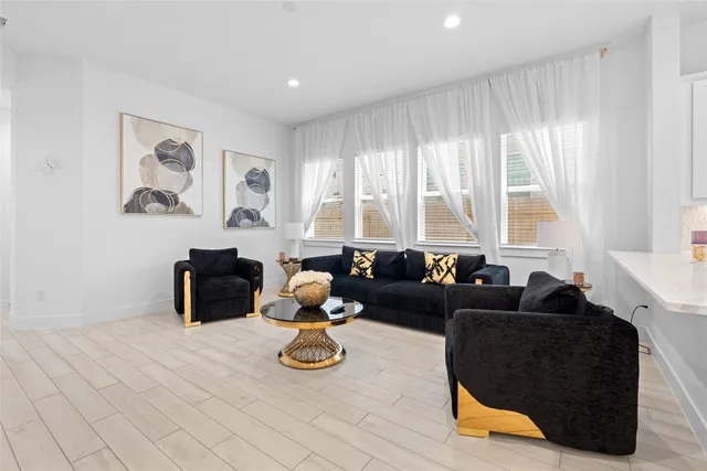 a living room with furniture and wooden floor