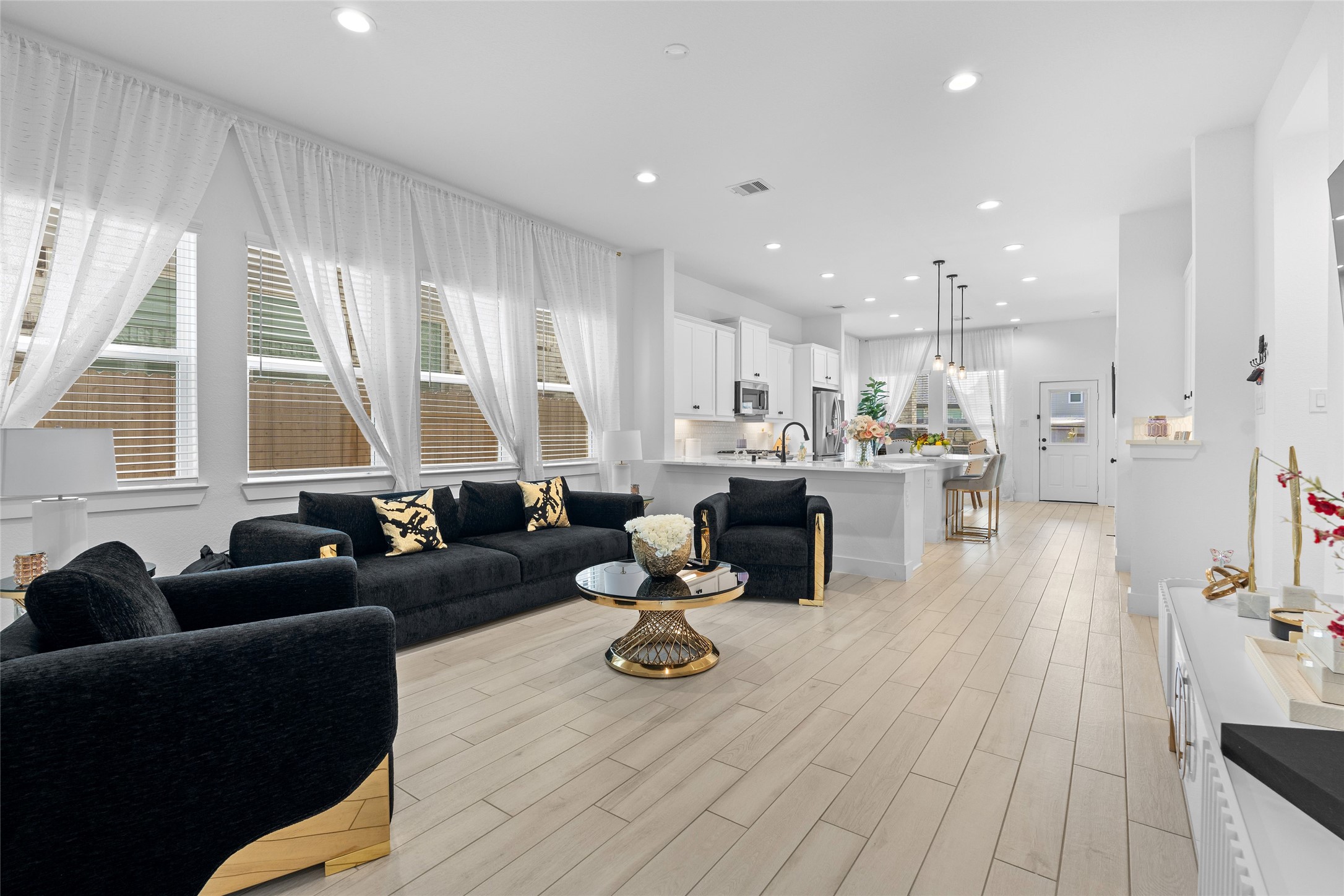 17735 Tree Of Heaven Conroe, TX 77385 - Photo 6 of 35 a living room with furniture wooden floor and a large window